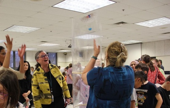 Dr. Reid watching science experiment