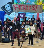Mr. Hill dressed as a pirate and leading the audience in song