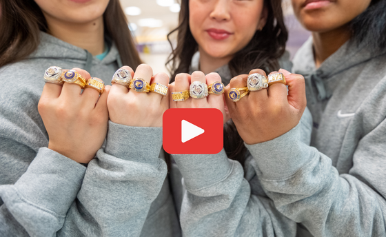 Gymnasts showing their hands wearing state championship rings