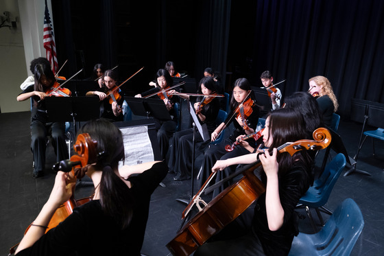 String quartet students seated playing instruments