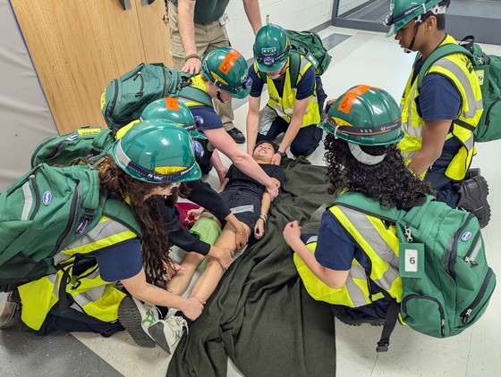 EMT students carry a "mock injured" student