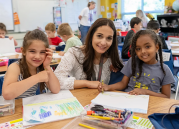 teacher smiles with students