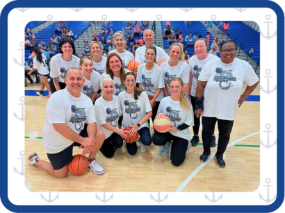 Staff Posing for Picture on Basketball Court