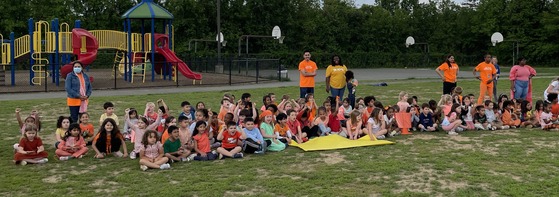 Kindergarten students chanting and cheering at Pep Rally on the field