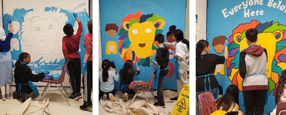 Students painting a new mural in the upstairs hallway