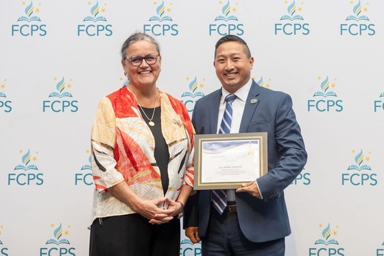 Dr. Reid smiles with a staff member