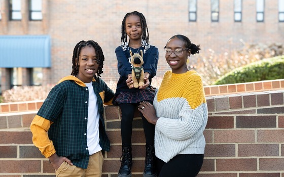 mom smiles with her two kids