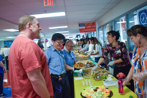 PTSA talking with TJ Staff as they serve them staff appreciation lunch.