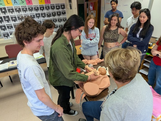 EMT students learn to deliver a baby