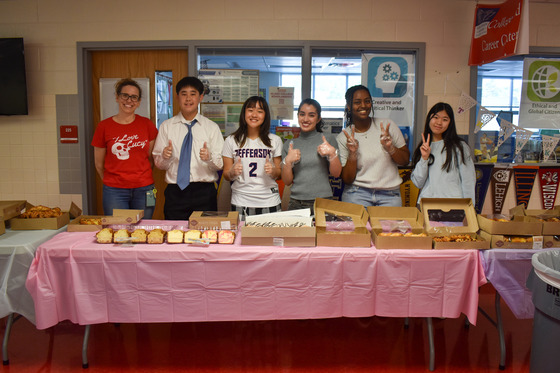 SGA students pose with the breakfast spread they have prepared for staff