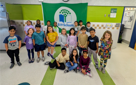 Students standing with Recycling flag 