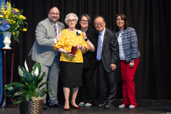 School Board Members standing with 49-year FCPS employee