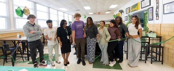 Students and staff cutting ribbon