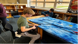 Students cutting fabric
