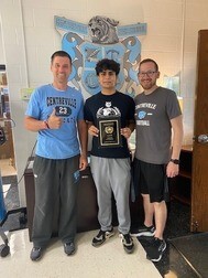 Student and Staff holding trophy