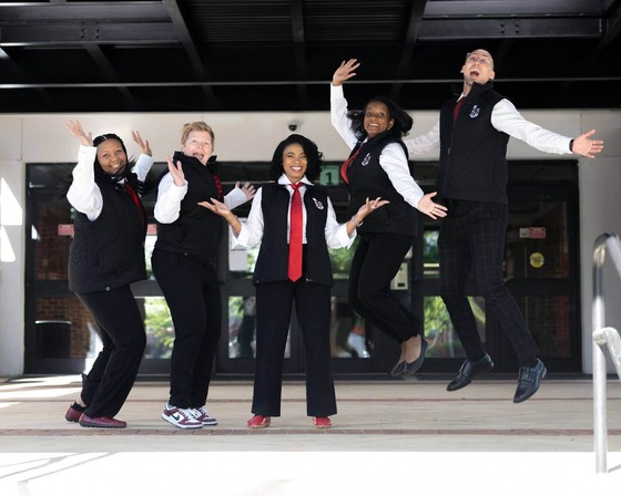 Administrators smiling and jumping for a photo