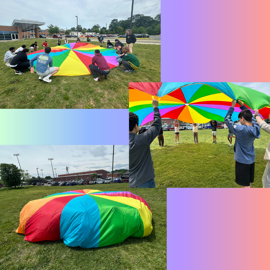 students playing with a big colorful parachute