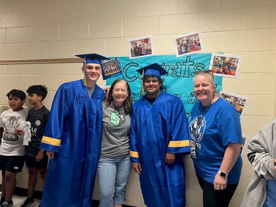 former students with their teacher