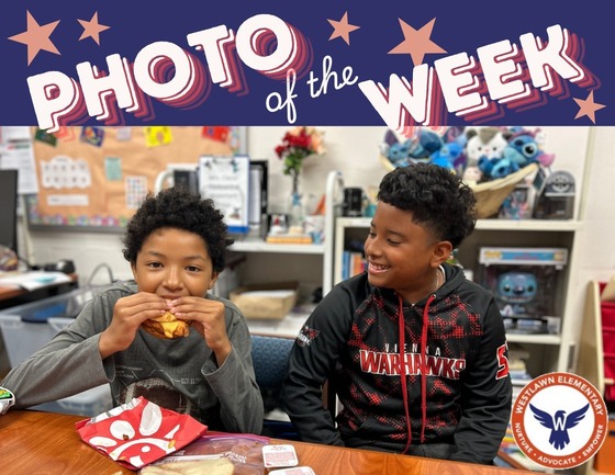 photo of the week: two boys smile while eating lunch in a staff member's office