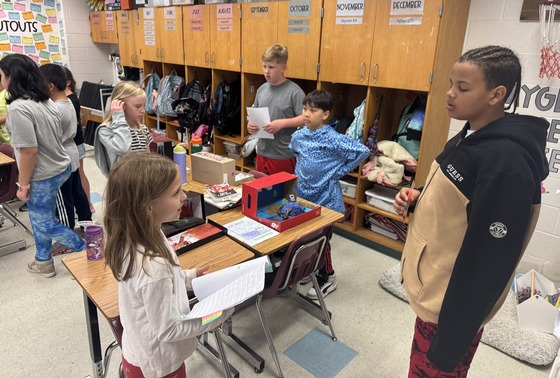 Ms. Brusick's 3rd graders presenting their natural disaster diorama projects to 5th graders