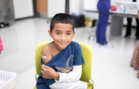 boy who has just received a vaccination in his arm