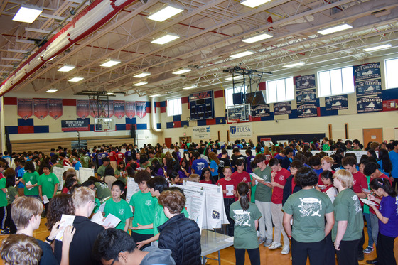 Class of 2028 in the gym showcasing their posters during IBEST Symposium