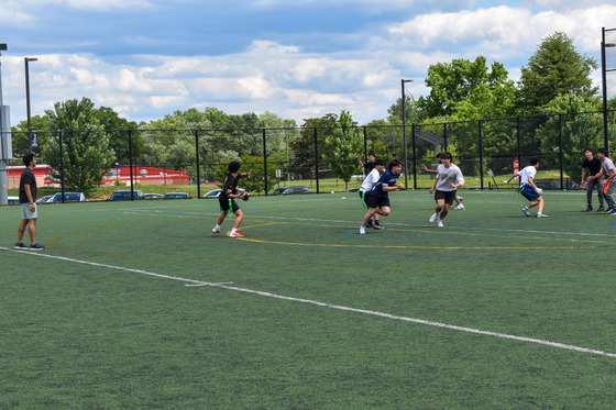 Students playing on the practice field during J-Day