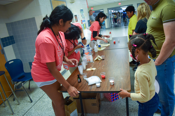Young child doing an experiment at Techstravaganza