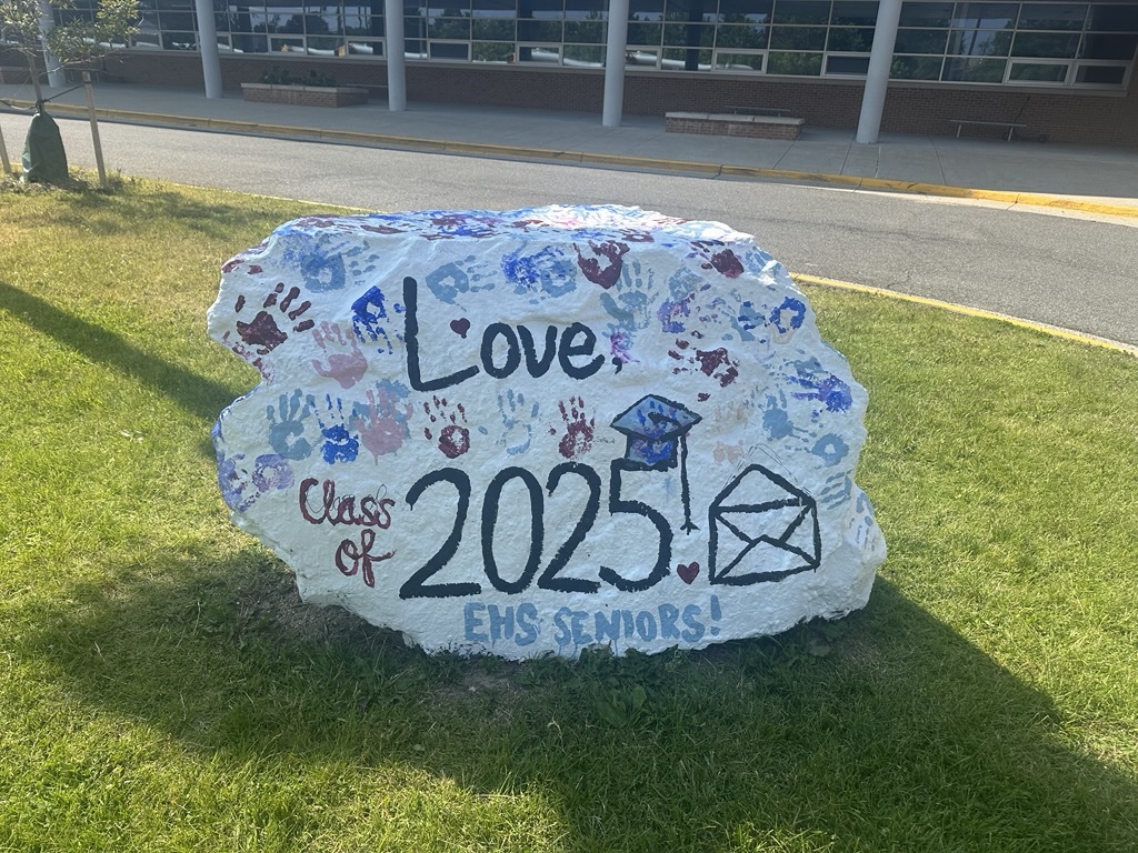 A large rock with the words Love class of 2025 painted on it.