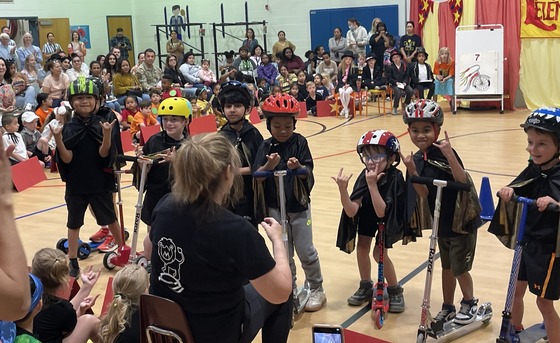 Kindergarten students with scooters as "Daring Bikers"