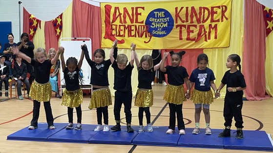 Kindergarten students dressed as acrobats taking a bow