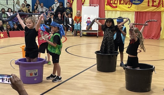 Kindergarten students performing as snake charmers and snakes