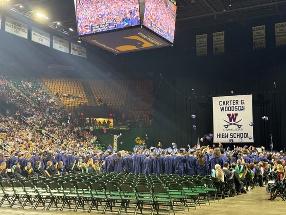 seniors throwing caps at graduation ceremony