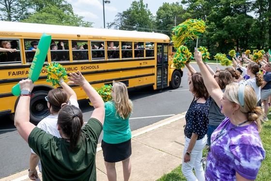 students wave goodbye