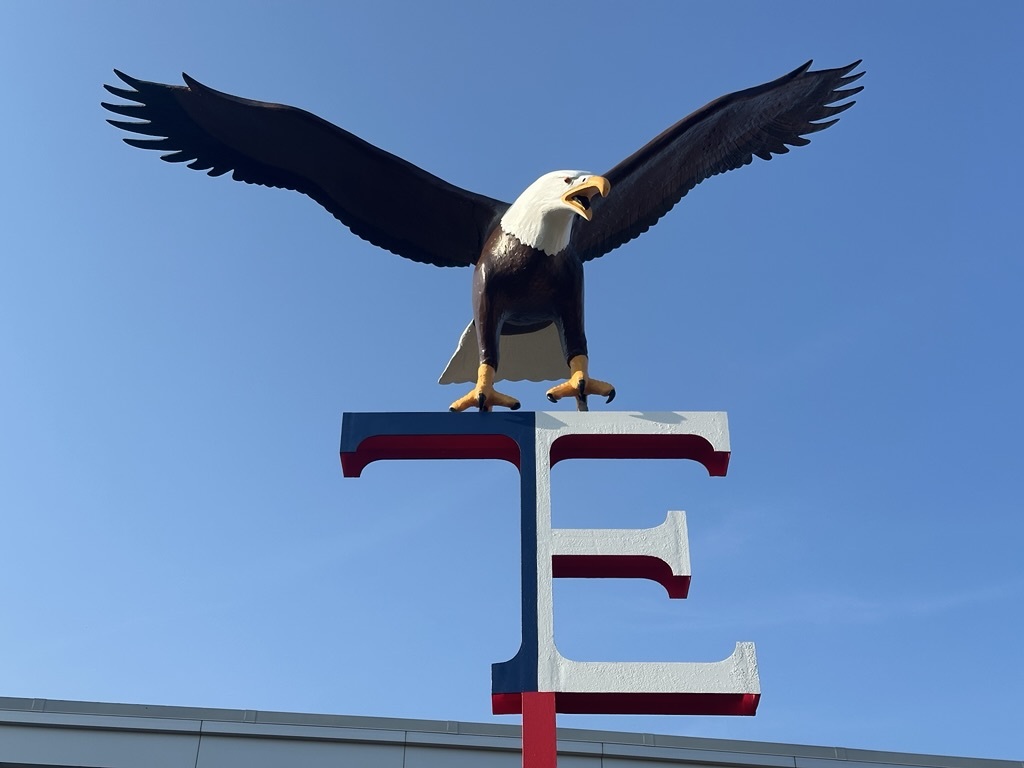 An eagle statue in the front of a school
