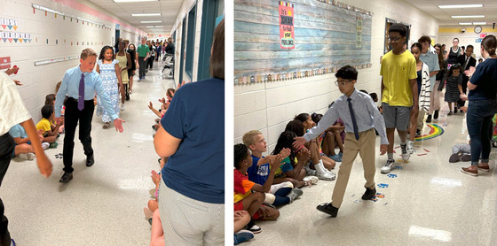6th grade students parading through the hallways to applause from younger students and staff