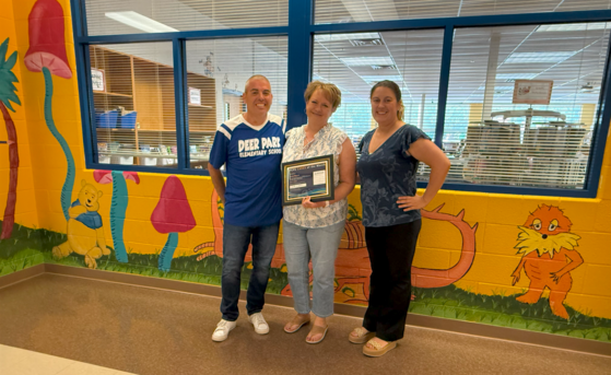 admin smiles with award winner