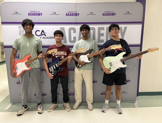 Students standing holding guitars