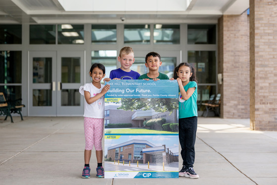 students smiling outside of a school