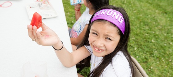 An FCPS student eating watermelon as part of the FCPS Summer Food Service.