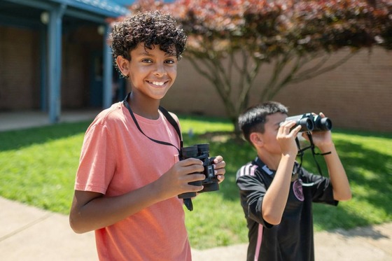 students looking through binoculars