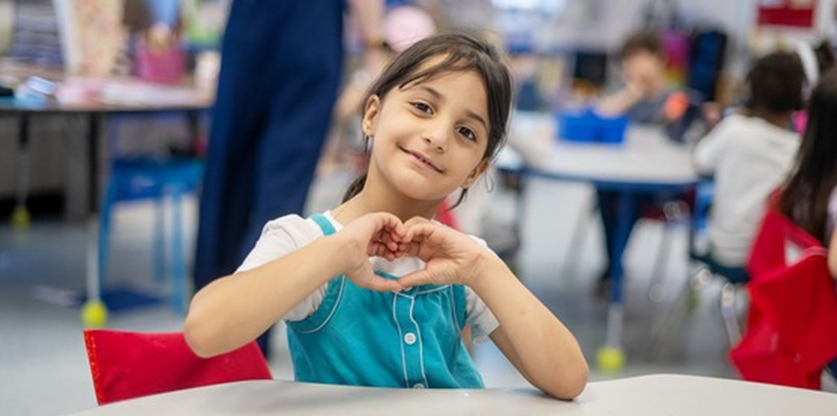 Join Team FCPS - student making heart hand symbol