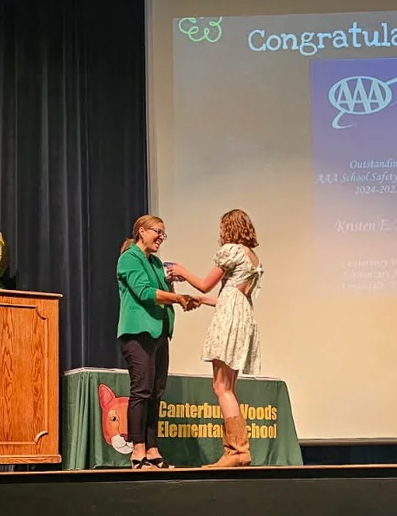 Canterbury Woods' grad Kristen King receives the Safety Patroller of the Year award at her sixth grade graduation ceremony.