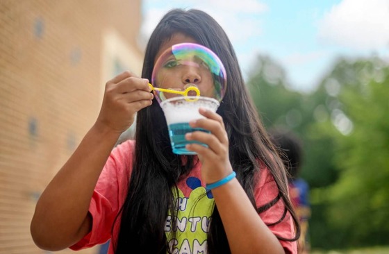 Student blows a bubble