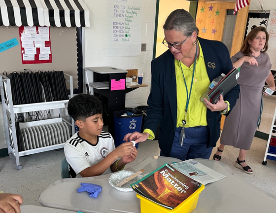 A student shows Dr. Reid a project that they are working on