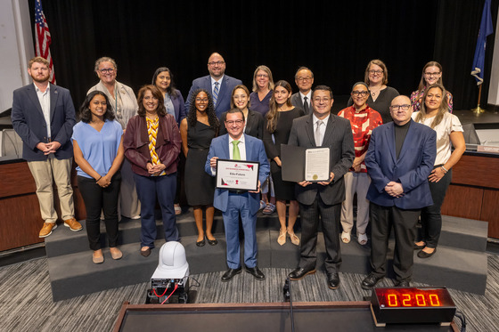 Edu-Futuro team holds honor roll certificate amongst FCPS staff and School Board members