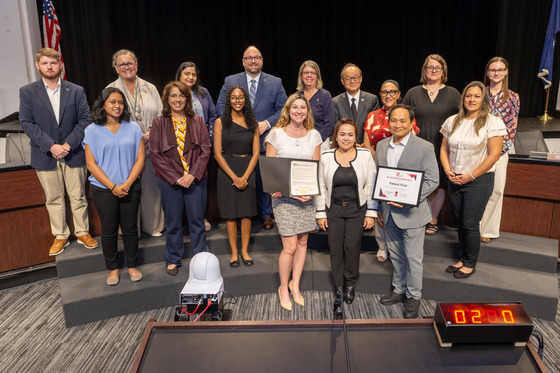 Patient First staff holds honor roll certificate amongst FCPS staff and School Board members