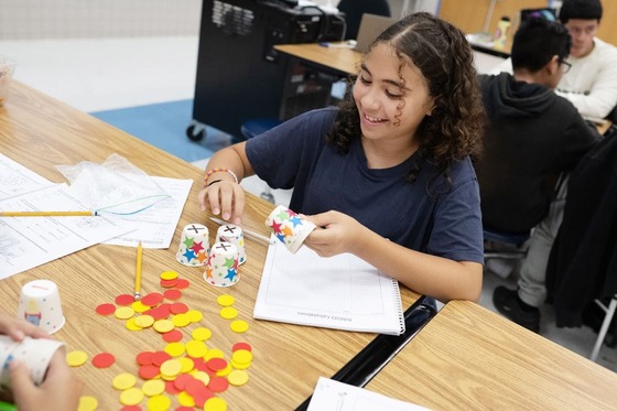 student sitting at a table working on a worksheet