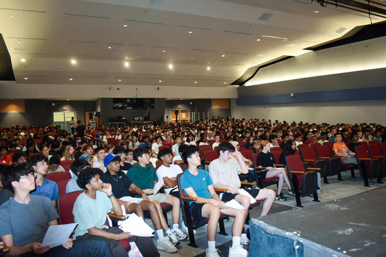 New TJ Students listening intently in auditorium 