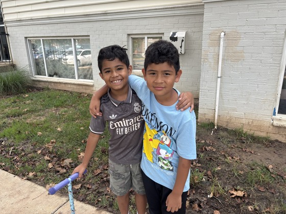 Students outside smile at the camera 
